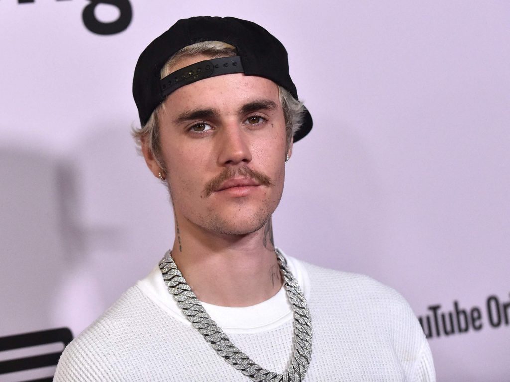 A man who defrauded nearly three million dollars by impersonating Justin Bieber and other artists was sentenced